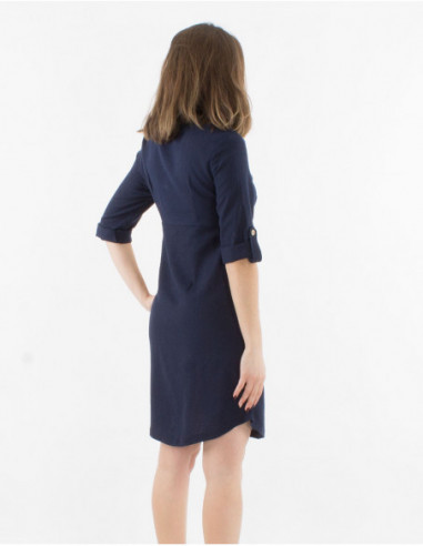 Women's dress with 3/4 sleeves with lapels and buttons in front of solid navy blue