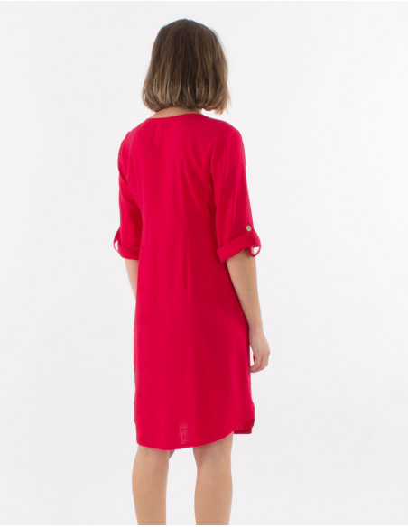 Women's dress with 3/4 sleeves with lapels and buttons in front of solid red